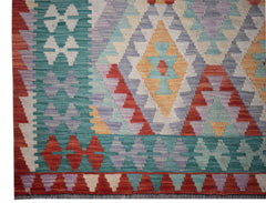 Handwoven Afghan Maimana kilim featuring a geometric diamond pattern in vibrant multicolored wool.