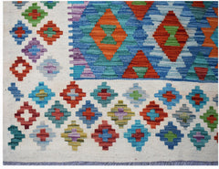 Afghan Maimana Kilim with geometric diamond patterns in red, blue, green, and purple.