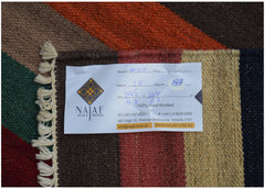 An Afghan Maimana Kilim rug featuring a geometric pattern in rich, warm colors.