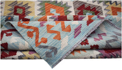 Handwoven Afghan Maimana kilim featuring a vibrant geometric pattern in wool.