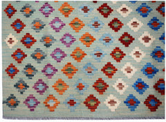 Afghan Maimana Kilim with geometric diamond patterns in various colors on a light blue background.