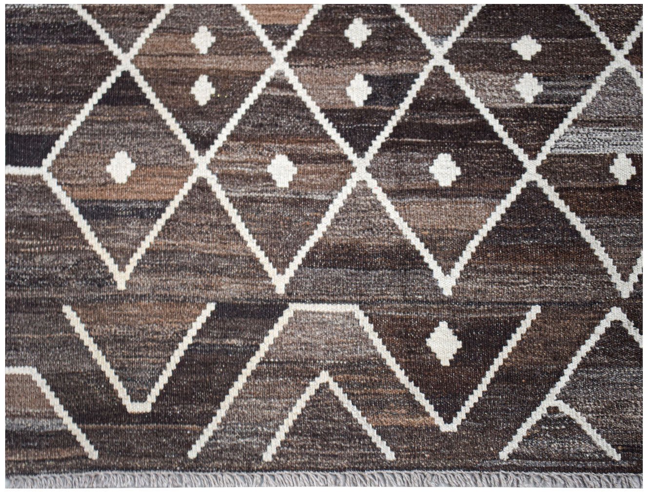 Handwoven Afghan Maimana kilim rug featuring a brown and white geometric diamond pattern.