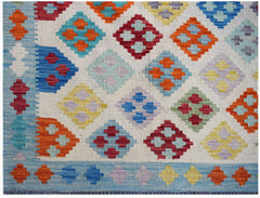 Handwoven Afghan Maimana kilim featuring a colorful geometric diamond pattern on a cream background.