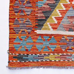 Handwoven Afghan Maimana kilim featuring a vibrant geometric pattern in wool.