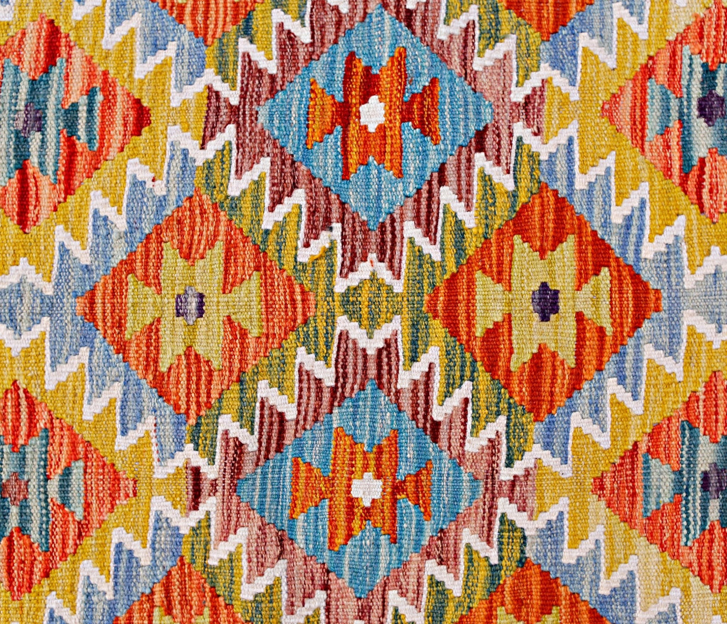 Handwoven Afghan Maimana kilim featuring a vibrant geometric pattern in orange, blue, and yellow.