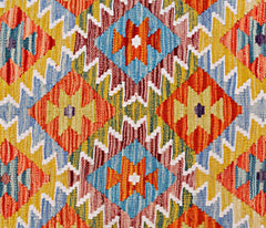 Handwoven Afghan Maimana kilim featuring a vibrant geometric pattern in orange, blue, and yellow.