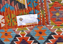 A handwoven Afghan Maimana kilim featuring a vibrant geometric pattern in wool.