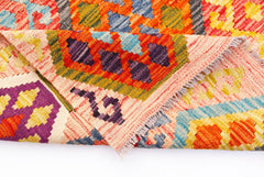A handmade Afghan Maimana kilim rug featuring a vibrant geometric pattern in wool.