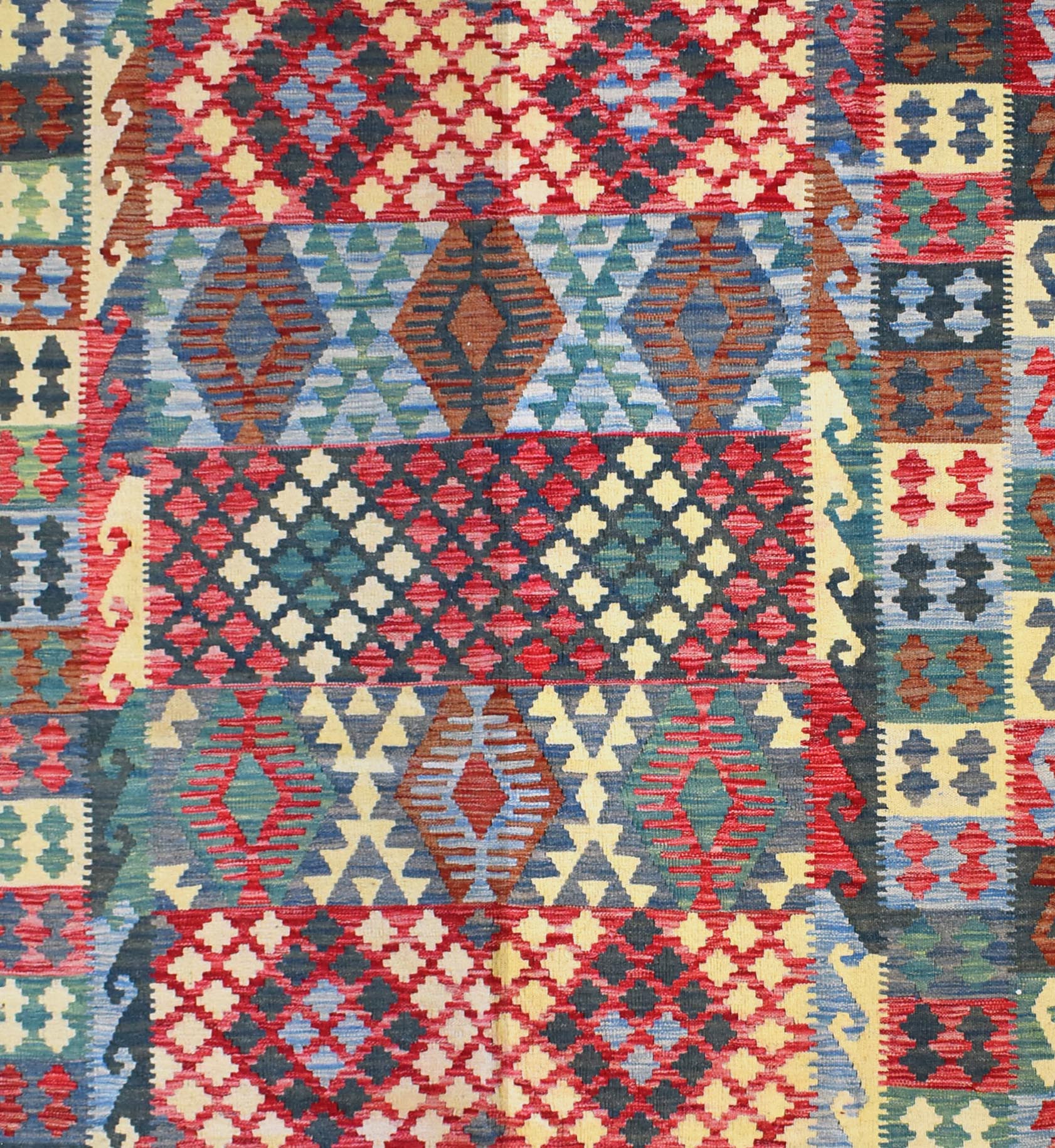 Handmade Afghan Maimana kilim rug featuring a vibrant geometric pattern in red, blue, and tan.