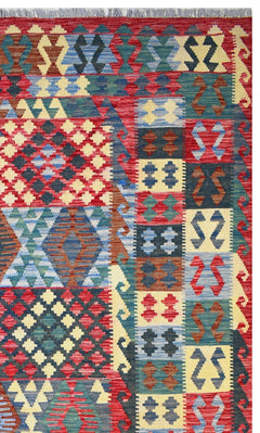 Handmade Afghan Maimana kilim rug featuring a vibrant geometric pattern in wool.