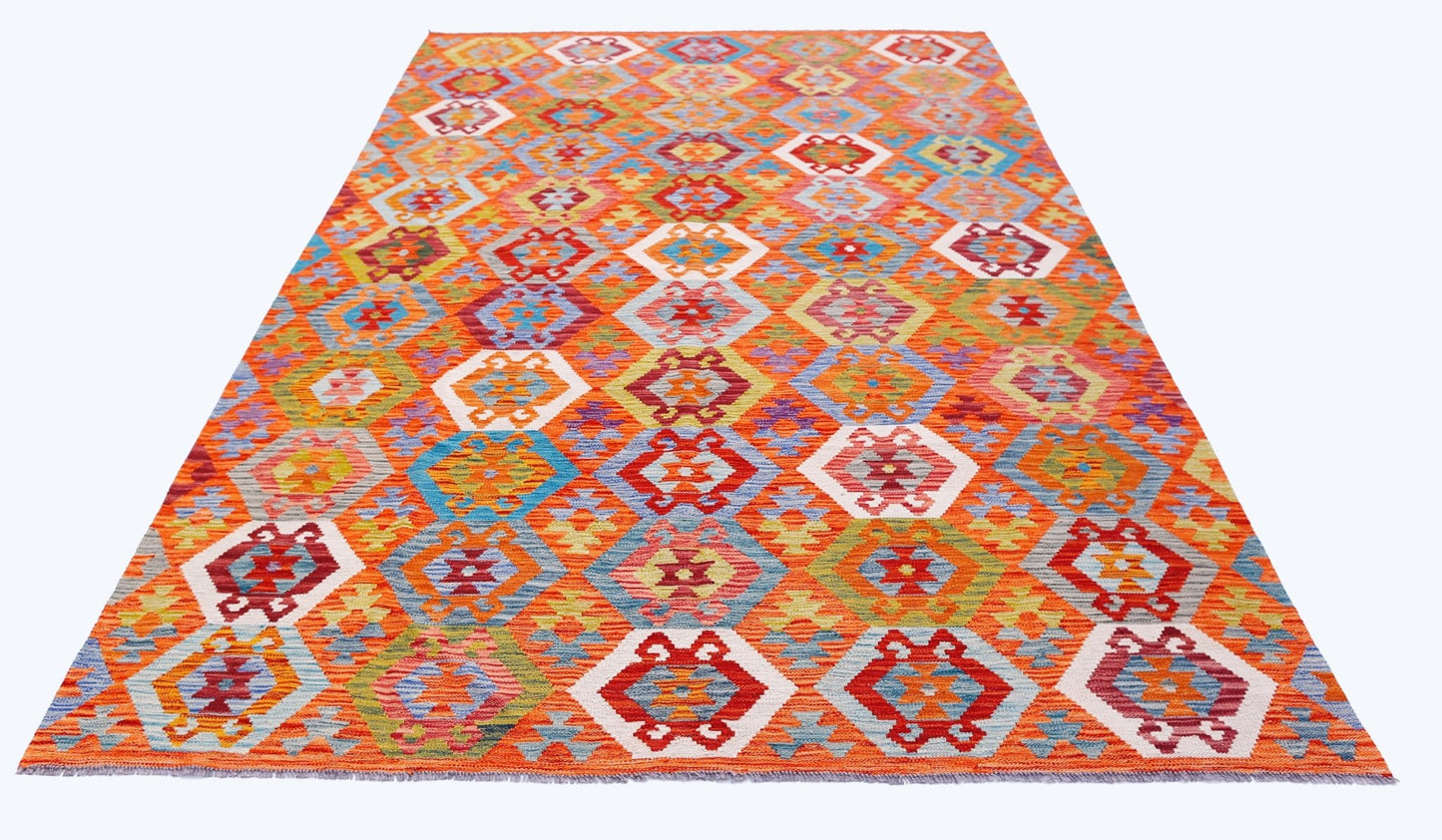 Handwoven Afghan Maimana kilim rug featuring a vibrant geometric pattern in wool.