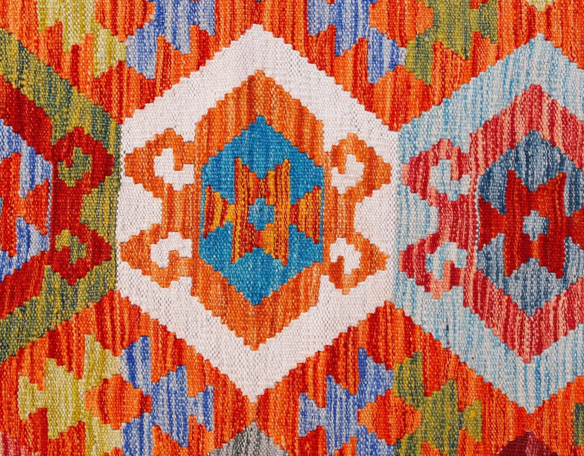 A handwoven Afghan Maimana kilim featuring a vibrant geometric pattern in wool.