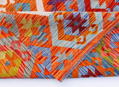 A handwoven Afghan Maimana kilim rug featuring vibrant geometric patterns in wool.