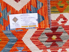 Handwoven Afghan Maimana Kilim featuring a vibrant geometric pattern in orange, red, and blue.