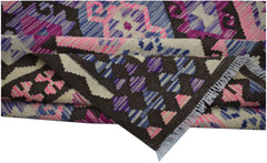 Handwoven Afghan Maimana kilim rug featuring a geometric pattern in pink, blue, and brown wool.