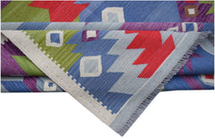 A handmade Afghan Maimana kilim rug featuring vibrant geometric patterns in wool.