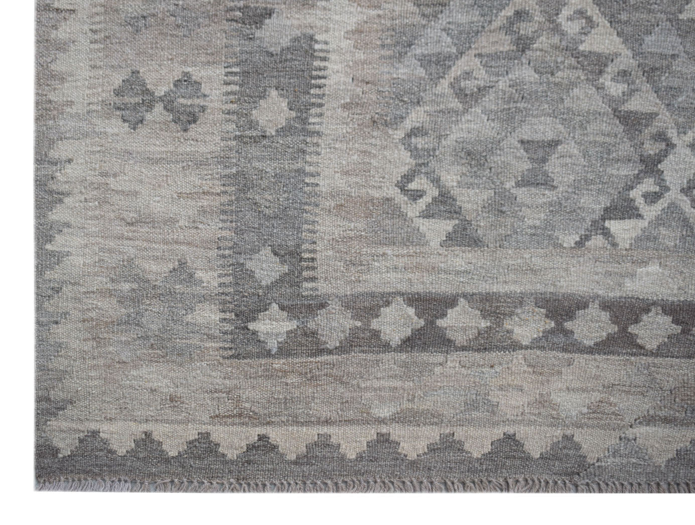 A handwoven Afghan Maiamana kilim rug featuring a grey and beige geometric pattern.