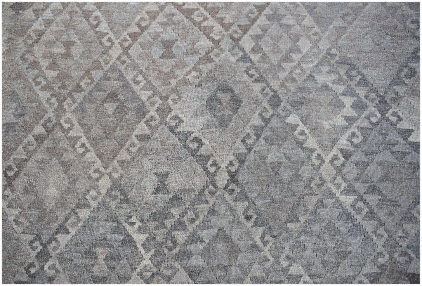 Handwoven Afghan Maiamana kilim rug featuring a grey and beige geometric diamond pattern.