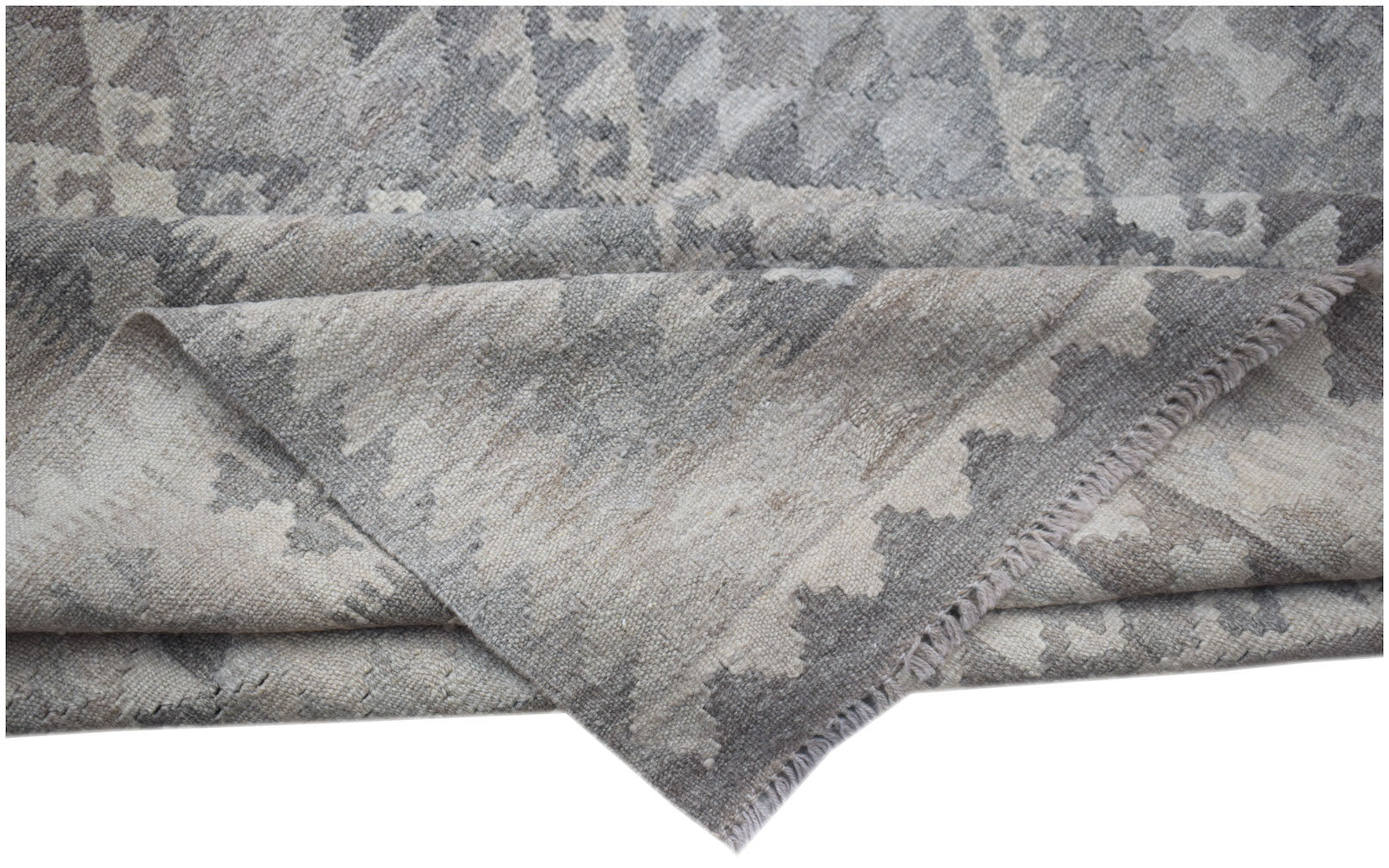 A handwoven Afghan Maimana kilim rug featuring a grey and beige geometric pattern.