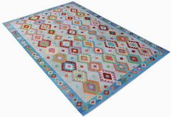 A handmade Afghan Maimana kilim rug featuring a light blue background with colorful geometric motifs.