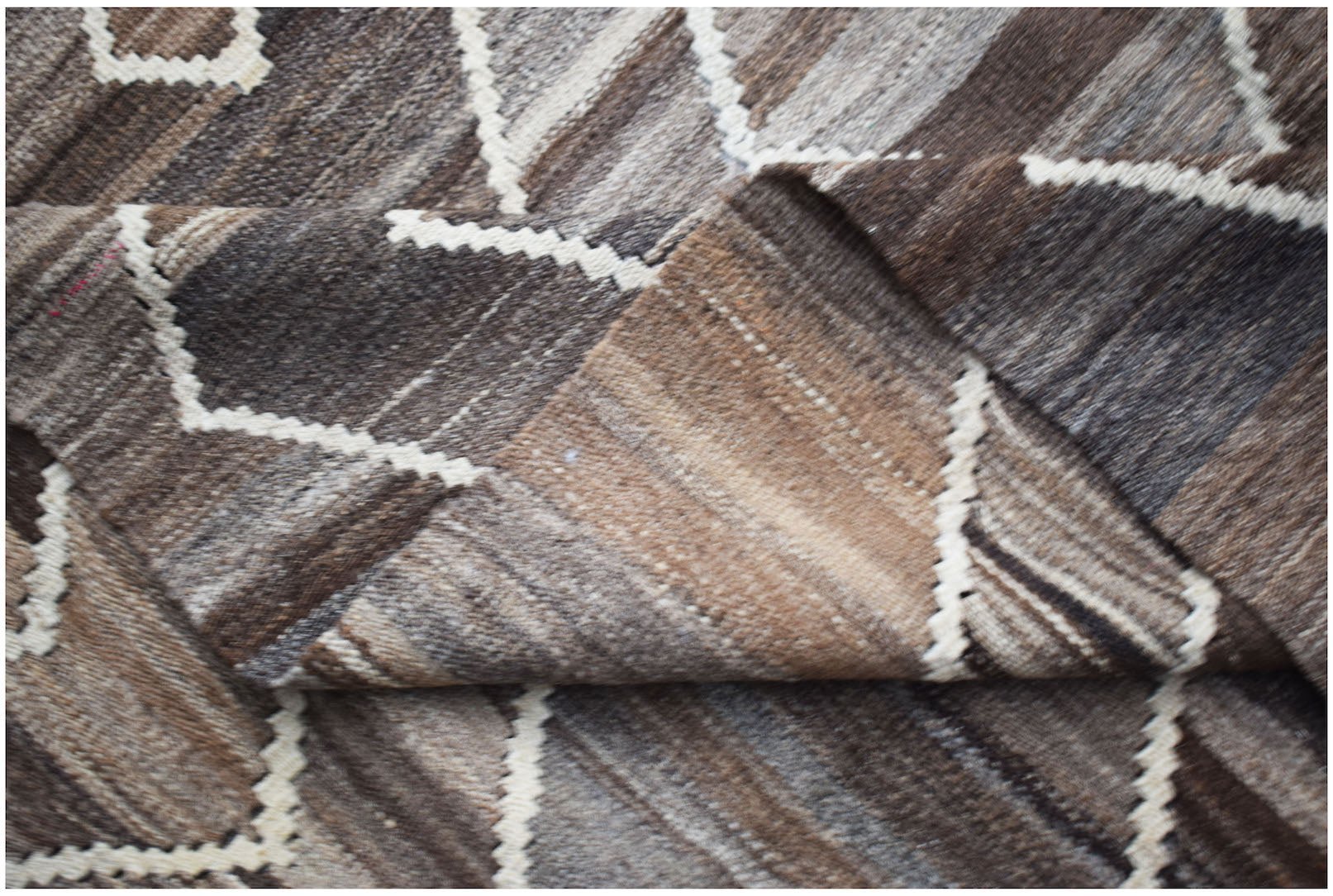 Afghan Maimana Kilim with geometric patterns in brown and white.