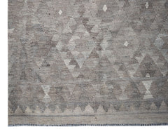 Handwoven Afghan Maimana kilim rug featuring a geometric pattern in neutral grey tones.