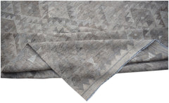 A handwoven Afghan Maiamana kilim featuring a neutral geometric pattern in undyed natural wool.
