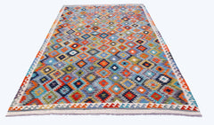 Handwoven Afghan Maimana kilim rug featuring a colorful geometric diamond pattern.