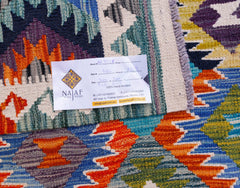 A handwoven Afghan Maimana kilim featuring vibrant geometric patterns in blue, orange, and purple.