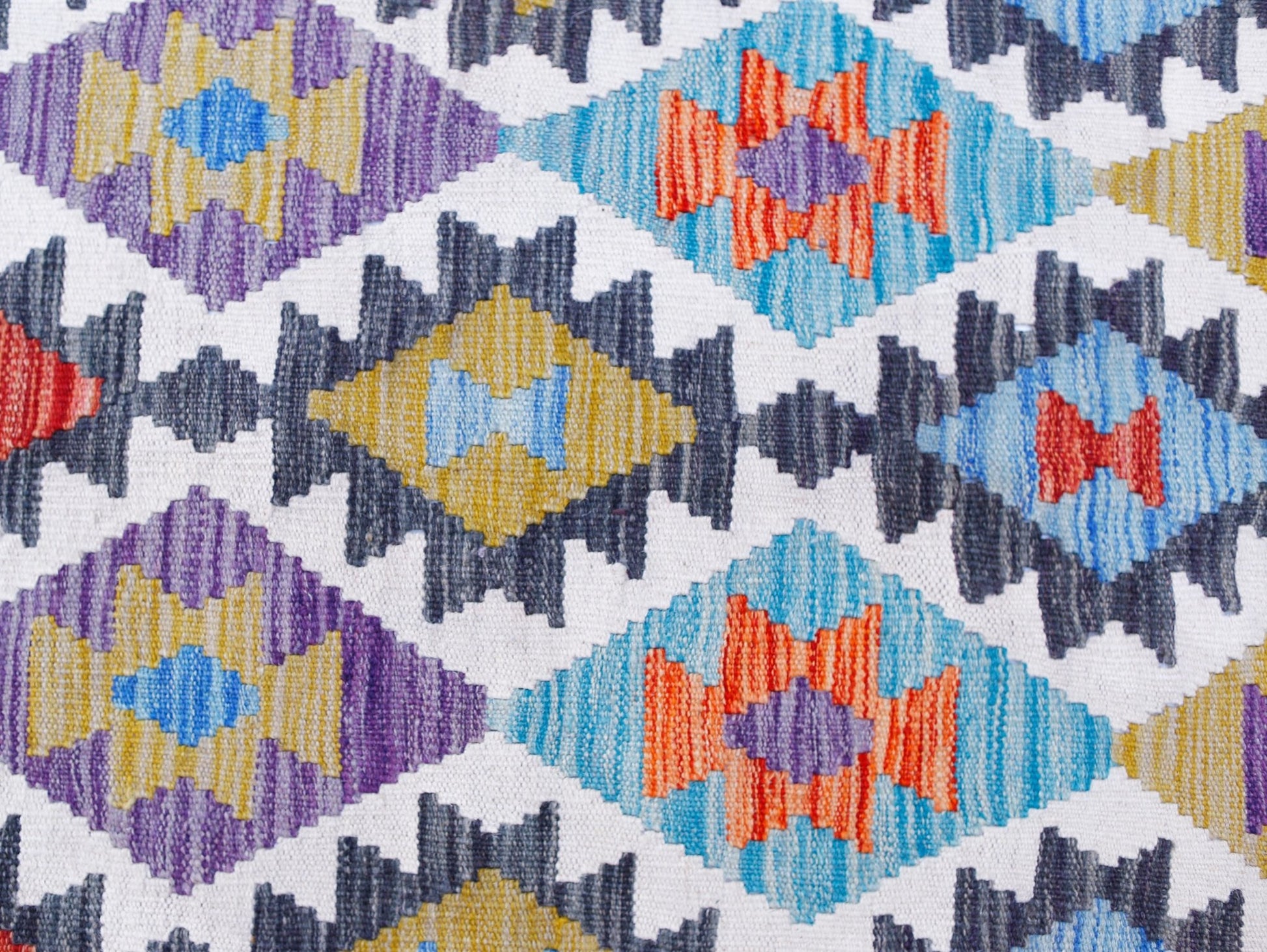 Handwoven Afghan Maimana kilim featuring a repeating geometric diamond pattern in vibrant colors.