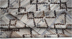 A handwoven Afghan Maimana kilim rug featuring a geometric pattern in neutral earth tones.