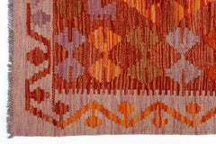 Handwoven Afghan Maimana kilim featuring geometric patterns in shades of orange, red, and purple.