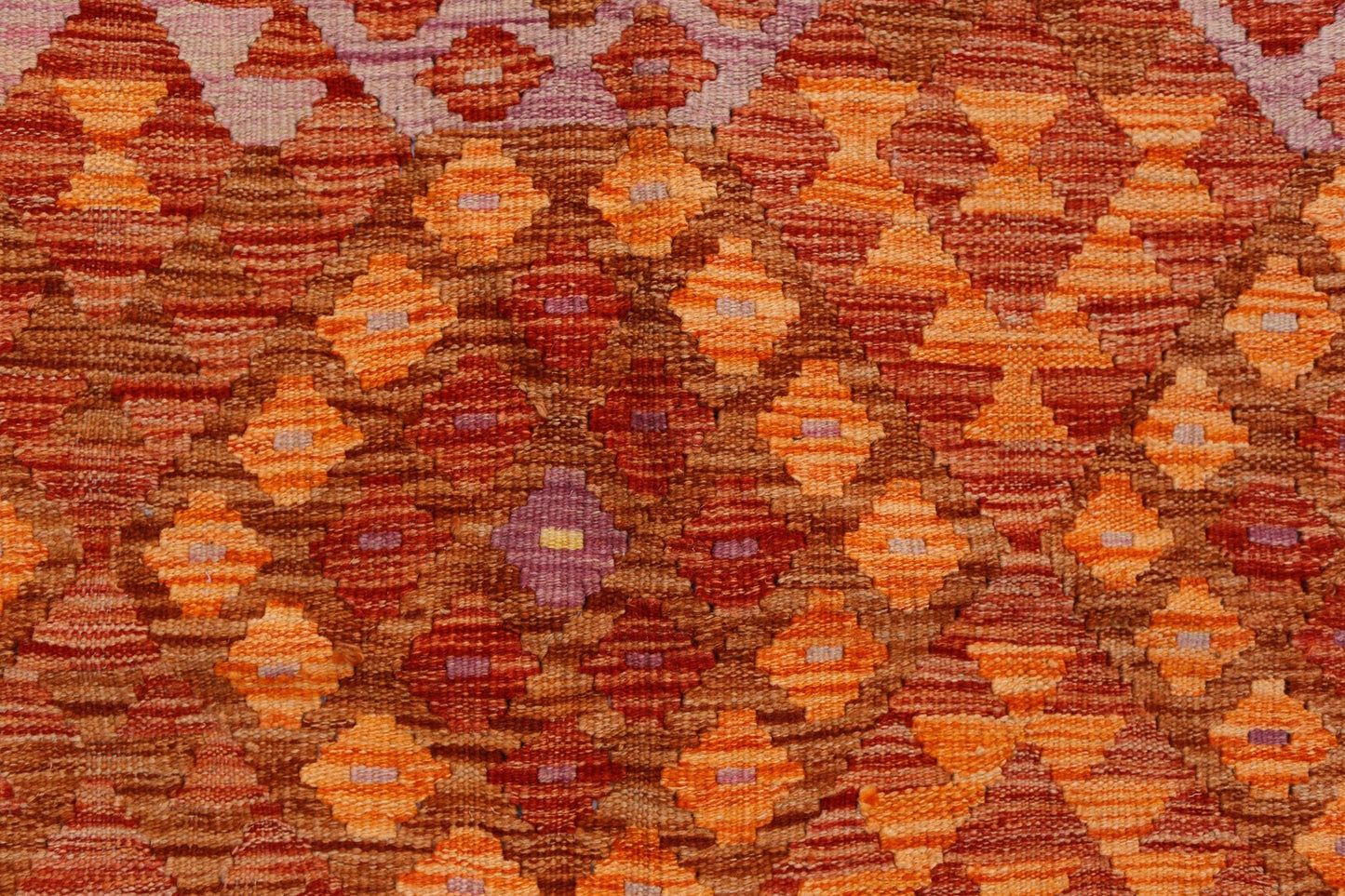 Handwoven Afghan Maimana kilim featuring a repeating geometric diamond pattern in warm earth tones.