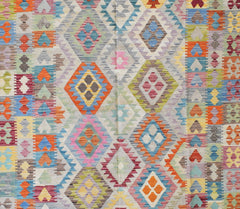 Handmade Afghan Maimana kilim rug featuring a vibrant geometric diamond pattern in wool.