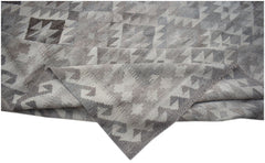 A handmade Afghan Maimana kilim rug featuring a grey and white geometric pattern in natural wool.