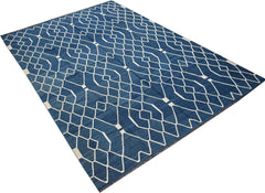 A handmade Afghan Maimana kilim rug featuring a geometric white pattern on a deep blue background.