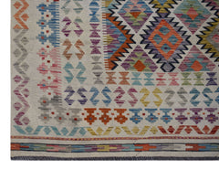 Handwoven Afghan Maimana kilim rug featuring a colorful geometric pattern on a cream background.