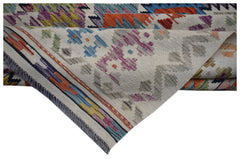 A handwoven Afghan Maimana kilim rug featuring colorful geometric patterns on a cream background.