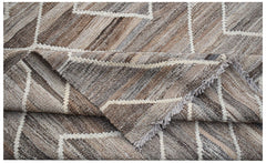 A handwoven Afghan Maimana kilim featuring a geometric pattern in shades of brown and cream.