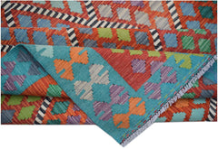 A handwoven Afghan Maimana kilim rug featuring a vibrant geometric pattern in wool.