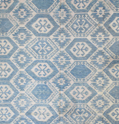 Handmade Afghan Maimana kilim rug featuring a repeating blue and white geometric pattern.