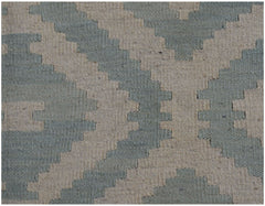 A handmade Afghan Maimana kilim rug featuring a geometric pattern in sage green and cream wool.