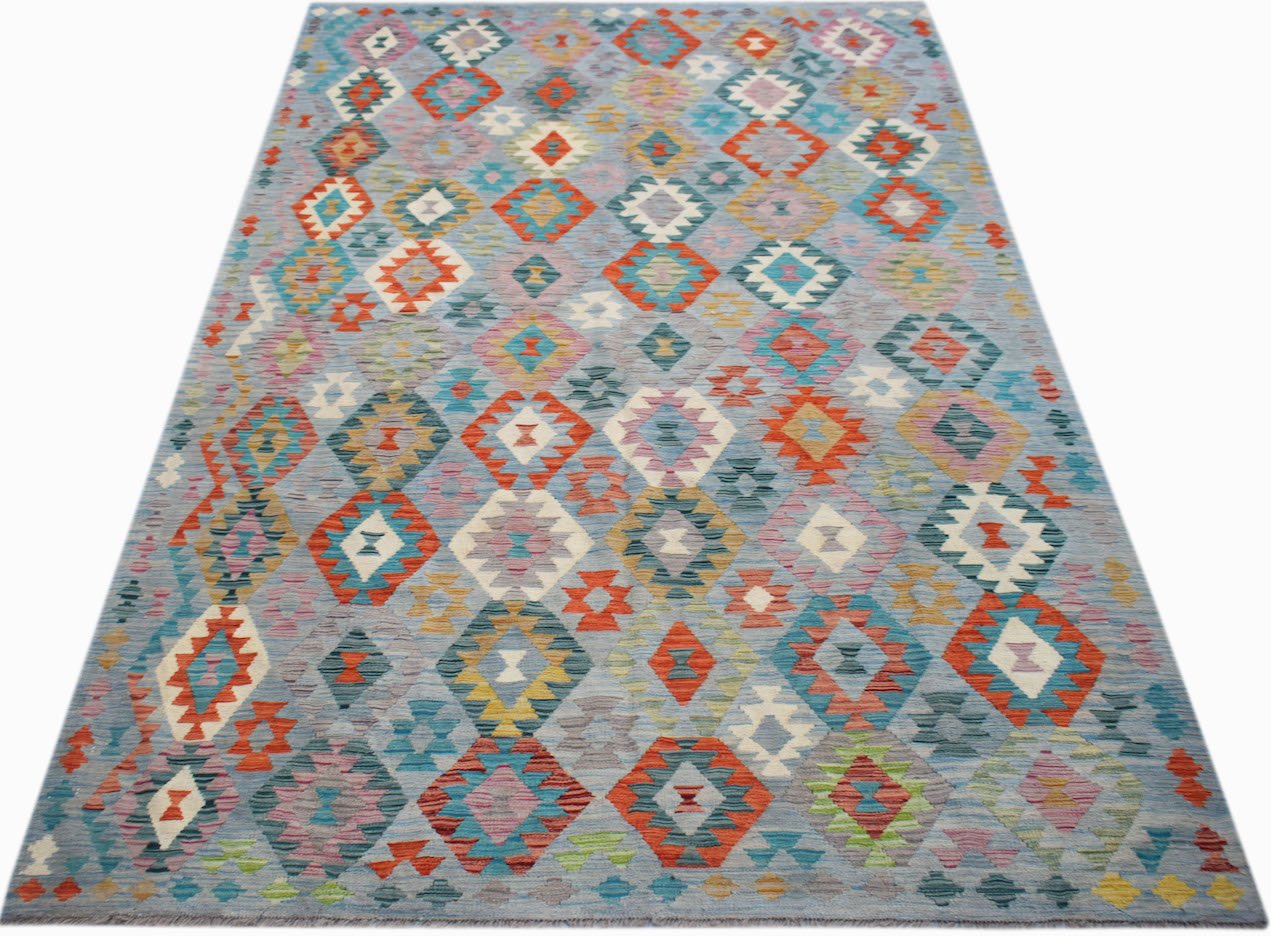 Handwoven Afghan Maimana kilim rug featuring a colorful geometric diamond pattern on a blue base.
