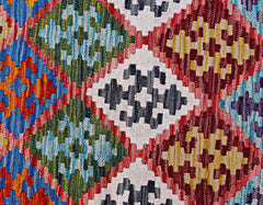 Handwoven Afghan Maimana kilim featuring a vibrant geometric pattern in wool.