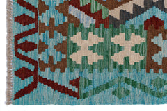A handmade Afghan Maimana kilim featuring geometric patterns in blue, green, and brown wool.