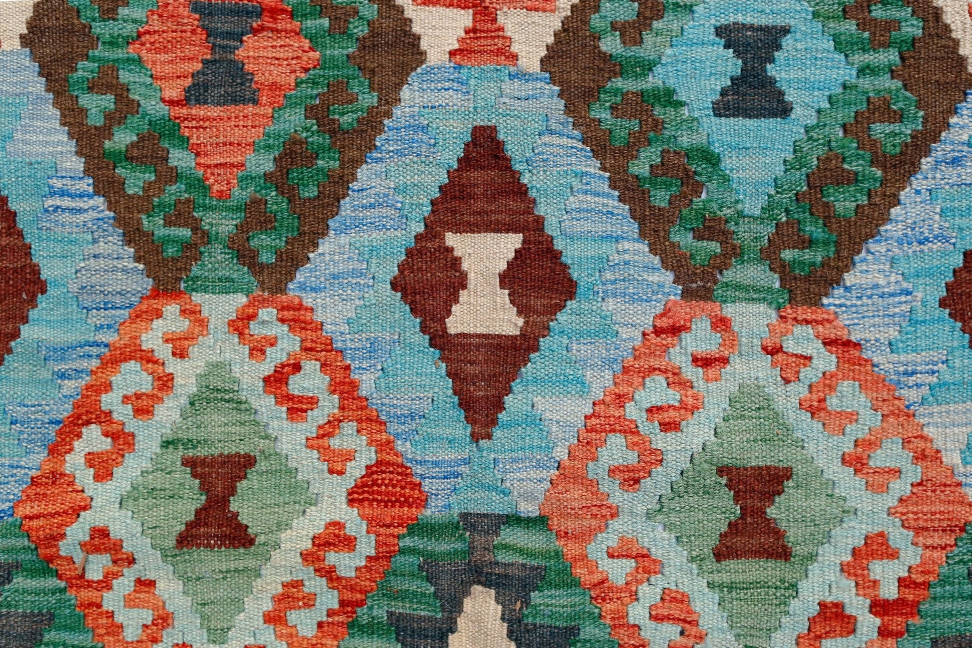 Handwoven Afghan Maimana kilim featuring a vibrant geometric diamond pattern in wool.