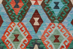 Handwoven Afghan Maimana kilim featuring a vibrant geometric diamond pattern in wool.