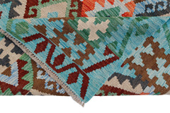 A handwoven Afghan Maimana kilim featuring a geometric pattern in blue, green, and brown wool.