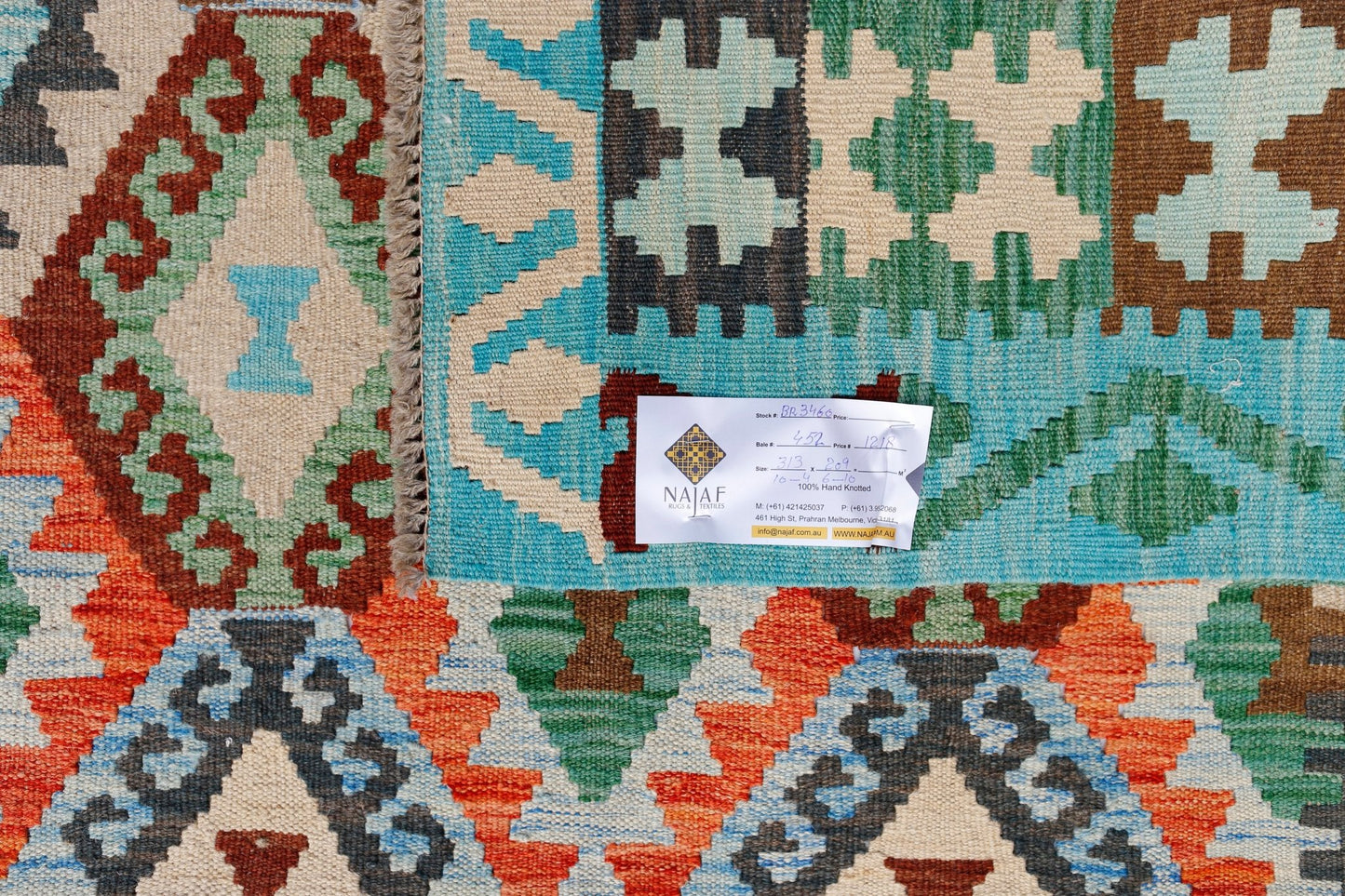 Handwoven Afghan Maimana kilim featuring a vibrant geometric pattern in wool.