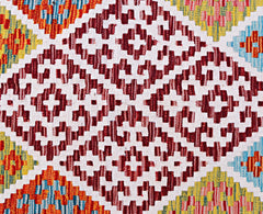 Handwoven Afghan Maimana kilim featuring a geometric pattern in red, white, yellow, and blue.